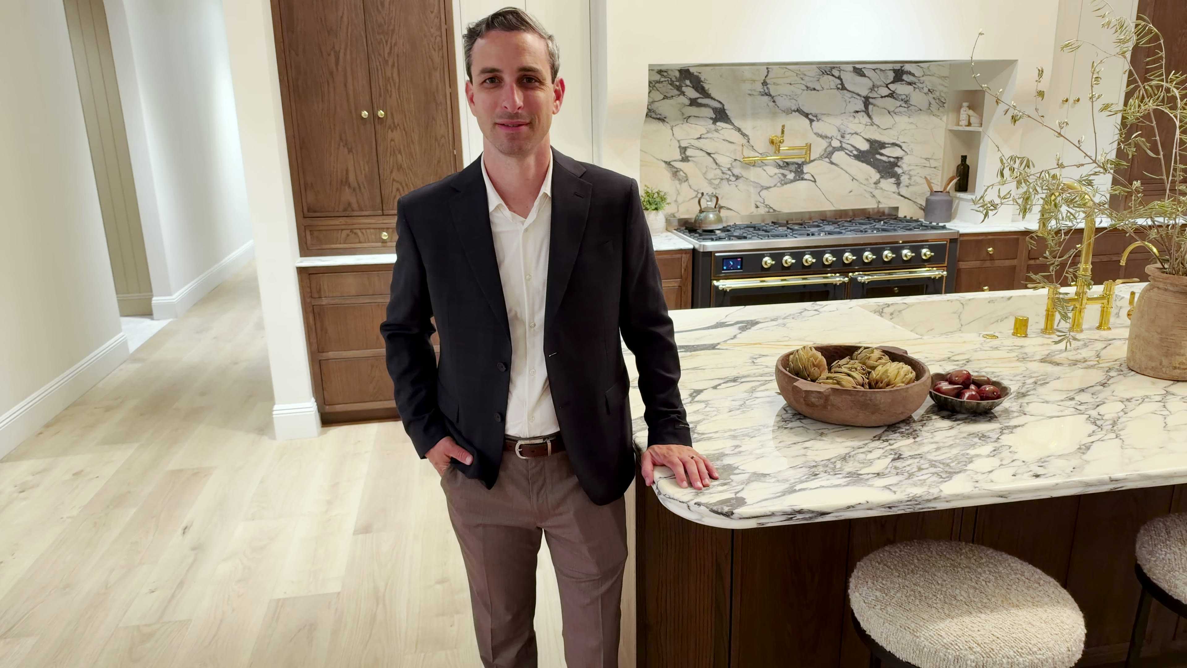 Aaron Benson standing at a marble kitchen island